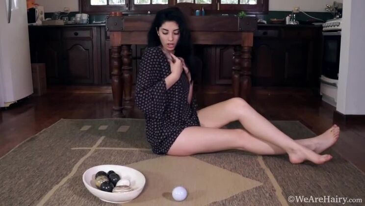 Hairy solo Ornella teases her wet pussy with rocks